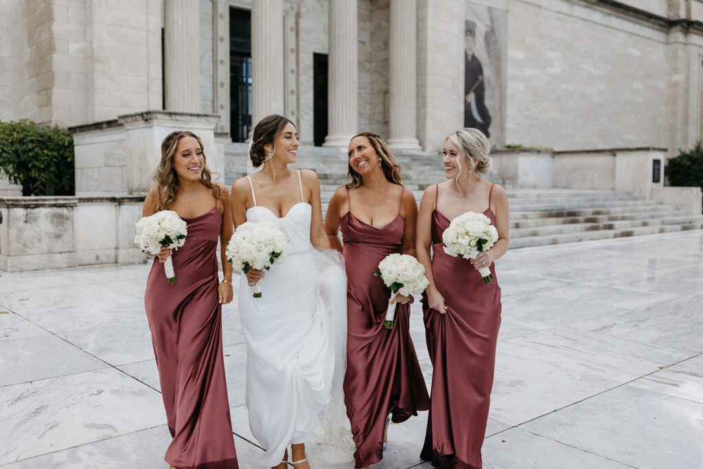 bride smiling with bridesmaids downtown cleveland oh
