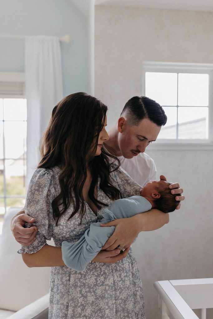 couple in nursery with newborn