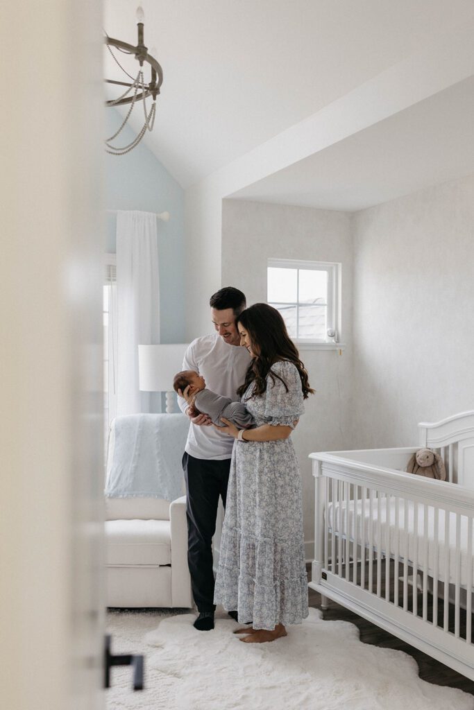 husband and wife wife newborn in nursery