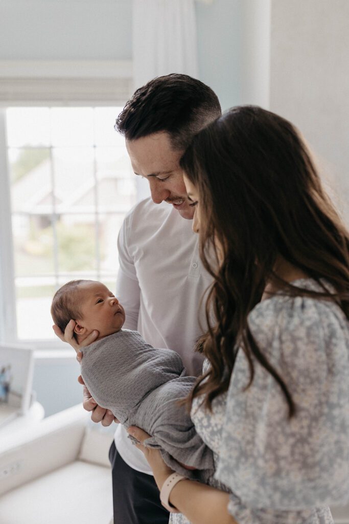 family photos with newborn in nursery