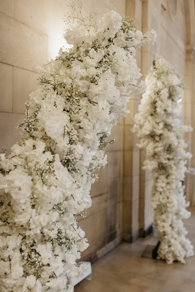 white floral arch wedding ceremony decor