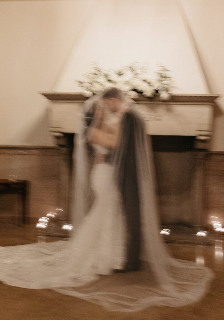 blurry candid indoor wedding portraits bride and groom under veil