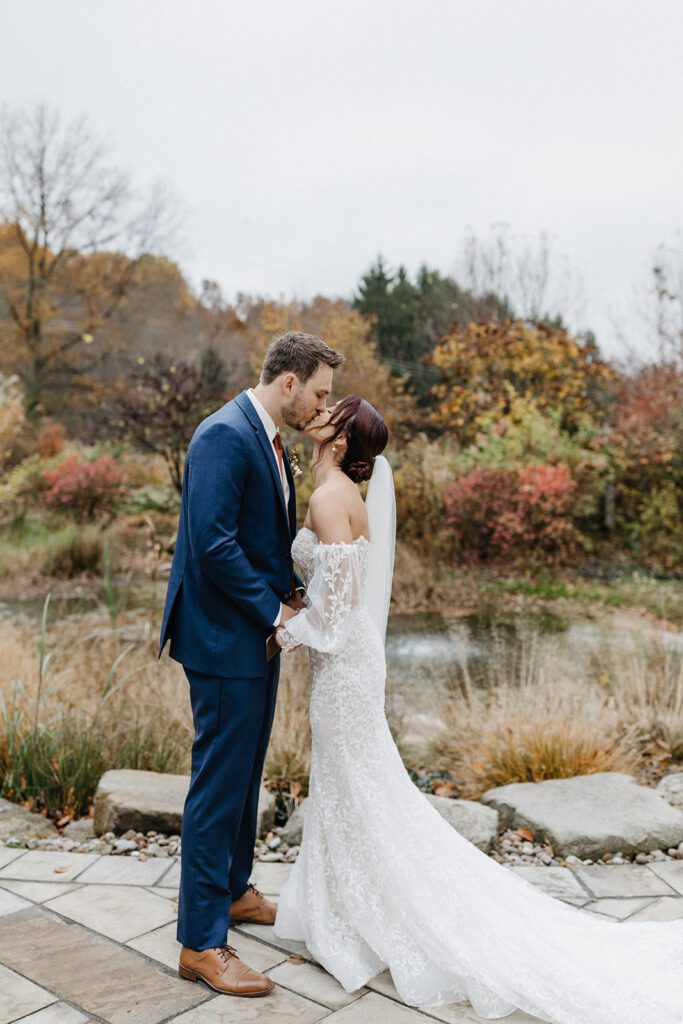 bride and groom kissing outdoor portraits